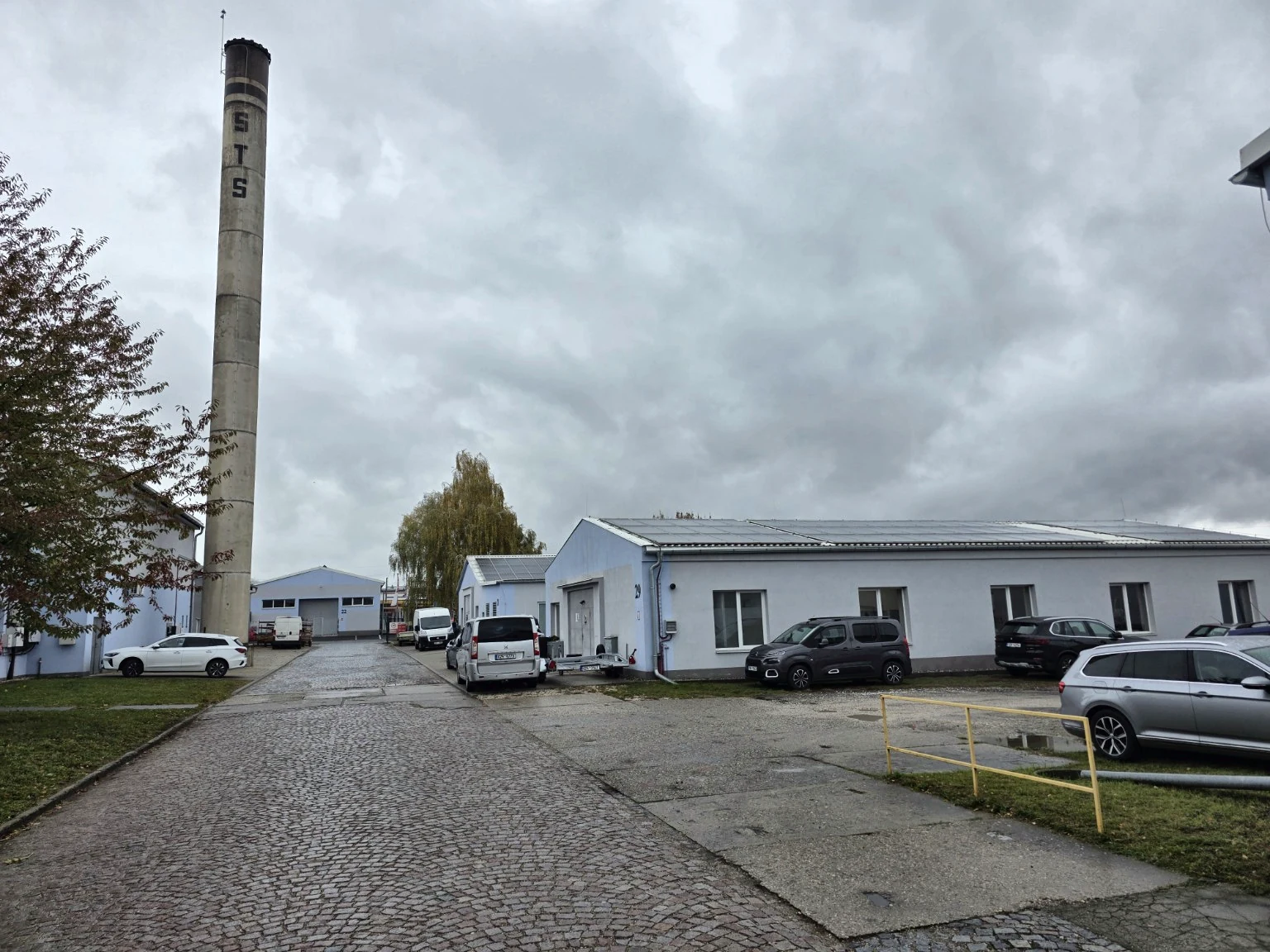 Skutečný pohled na areál s vysokým komínem STS